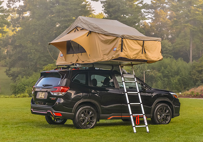A tent mounted to the roof of a Subaru Forester