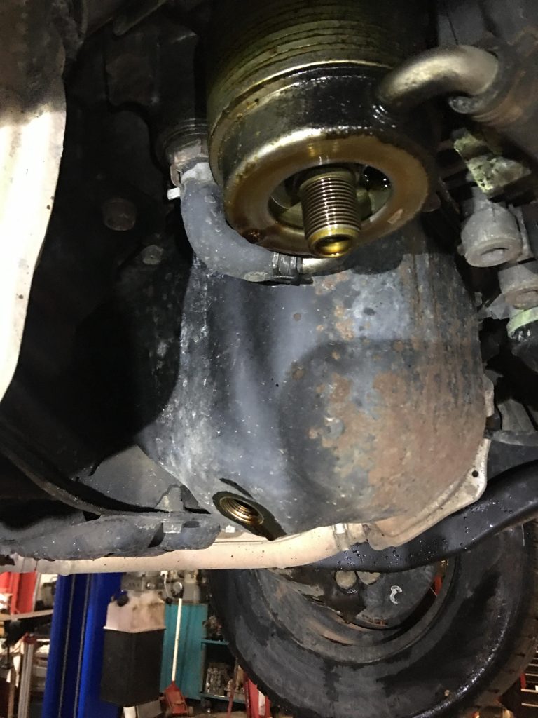 The oil filter housing after the oil filter was removed. tube/bolt sticking out.