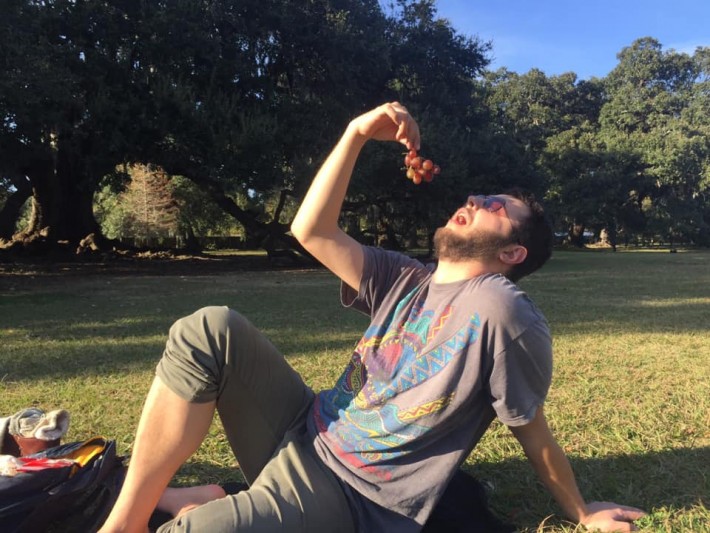 Man eating grapes