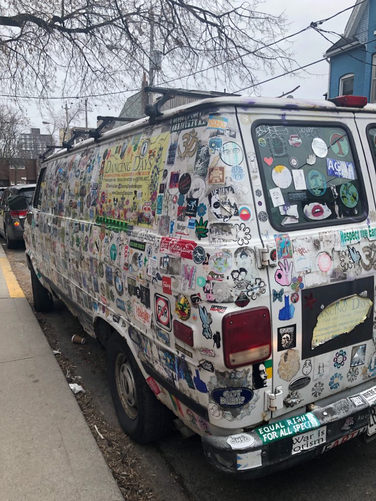 White van covered in bumper stickers